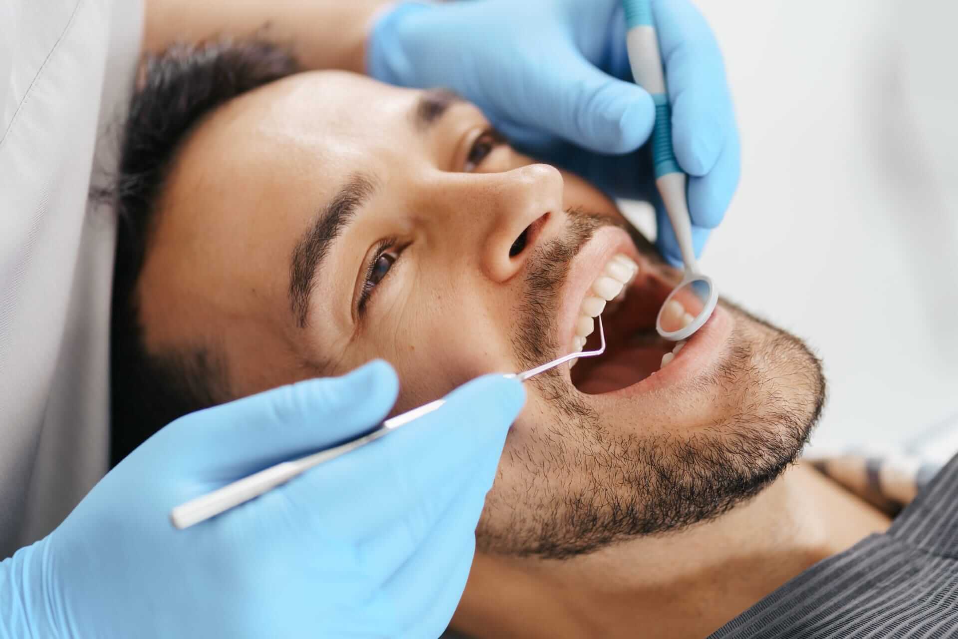 Man getting his teeth cleaned at the dentist